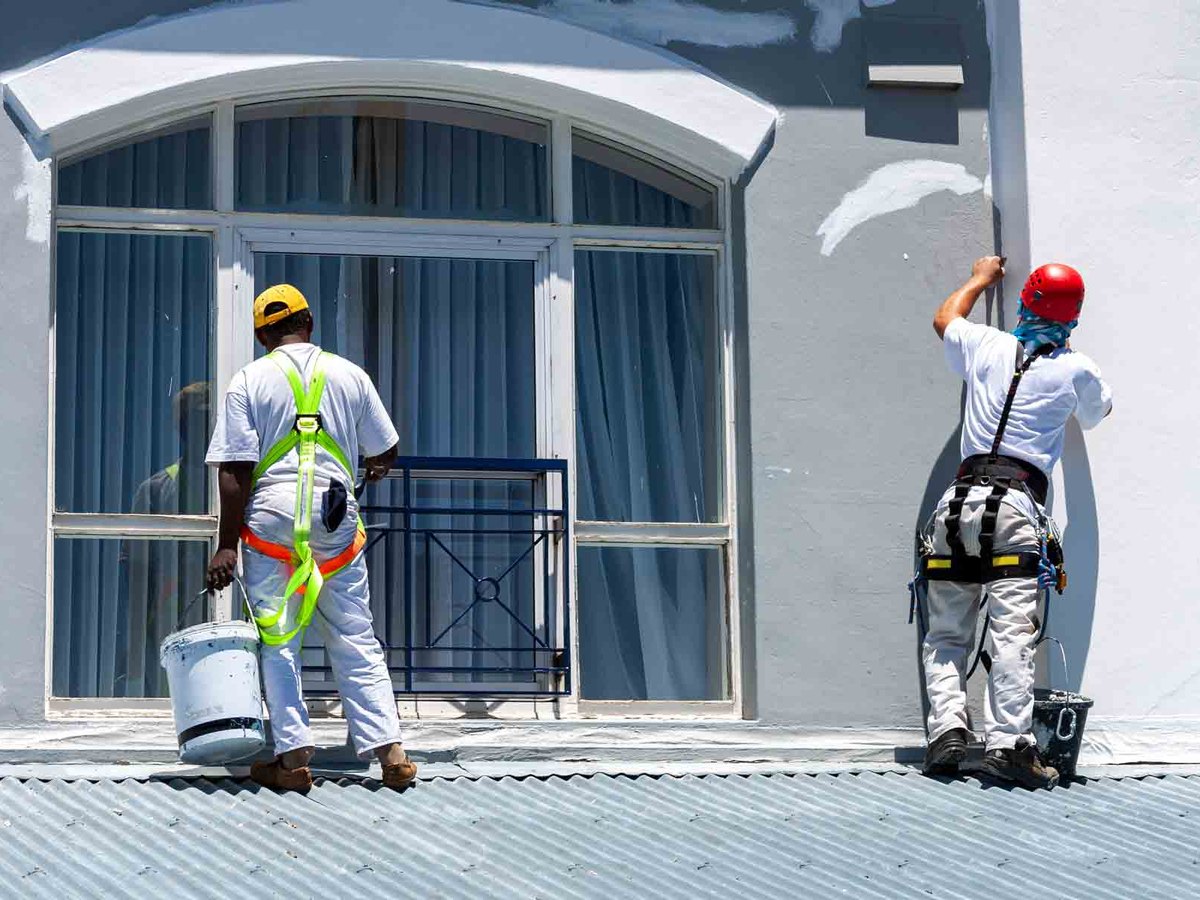 Commercial painting — two painters working on a building exterior