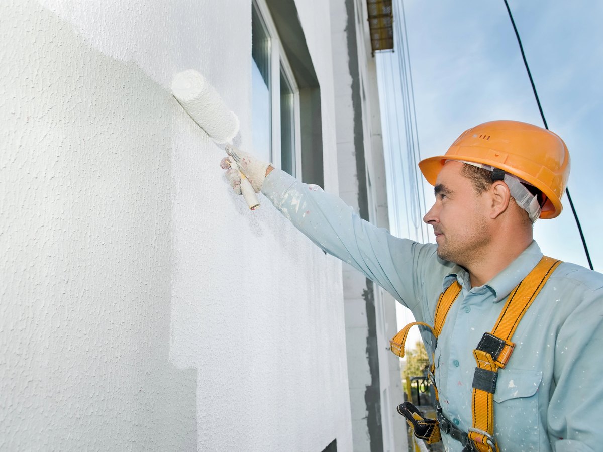 Exterior painting in Woodstock, GA — roller on a house wall