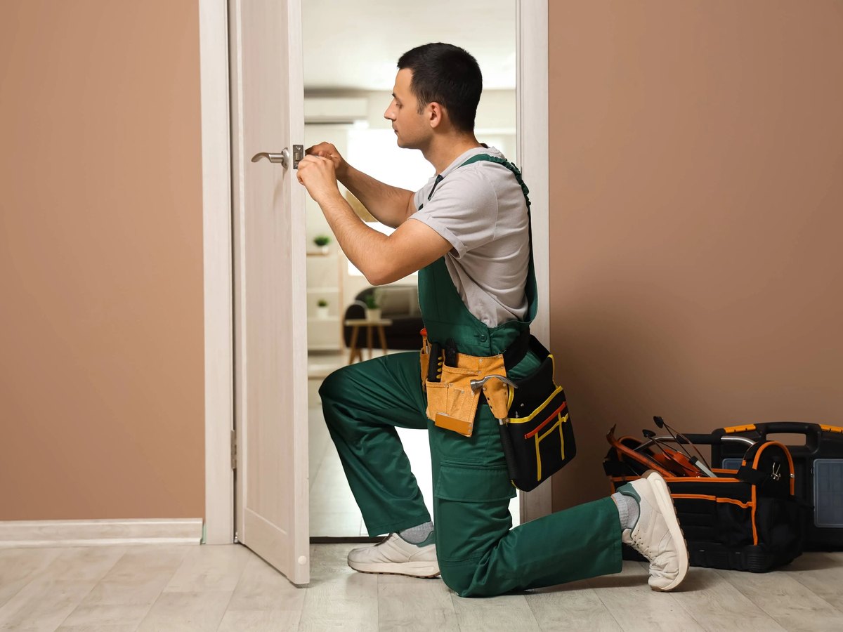 Handyman fitting a door latch