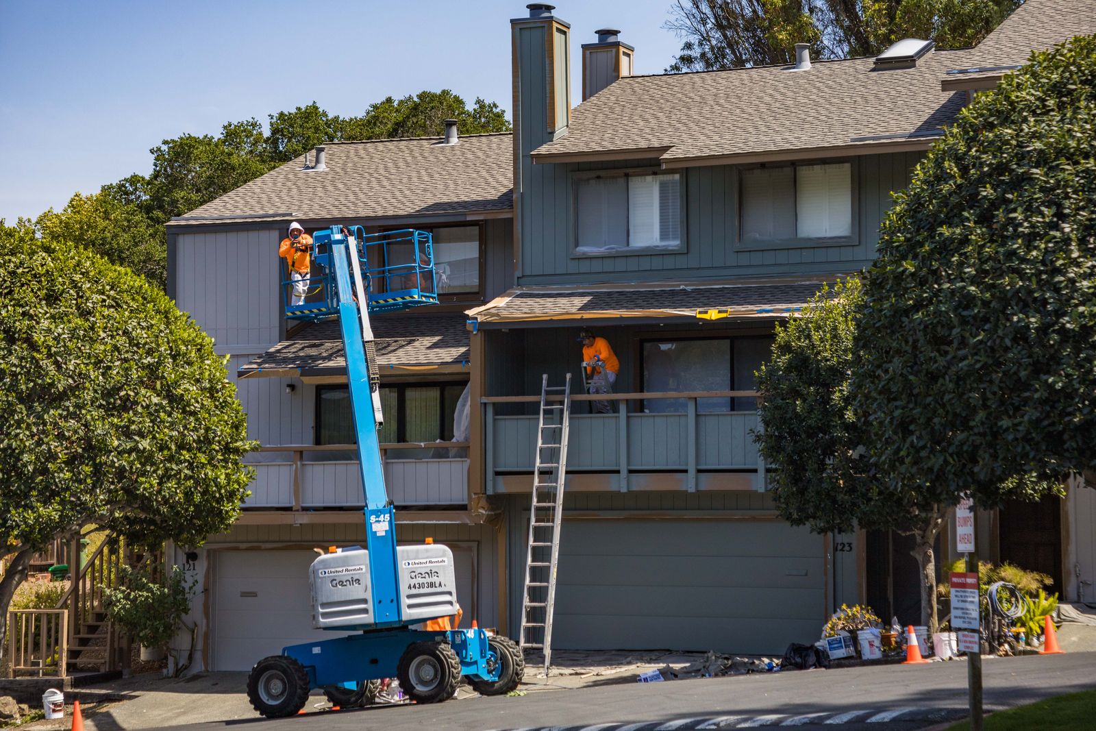 A house being repainted from a lift
