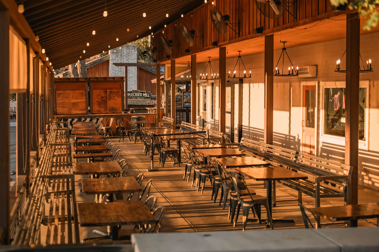 An outdoor patio with wooden tables