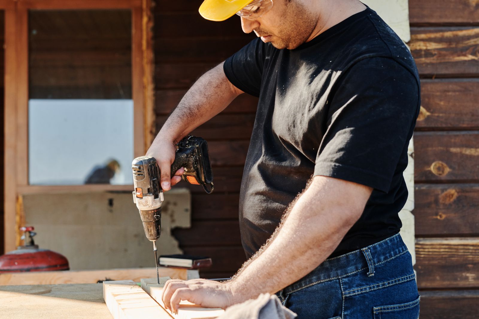 A construction worker using a power drill